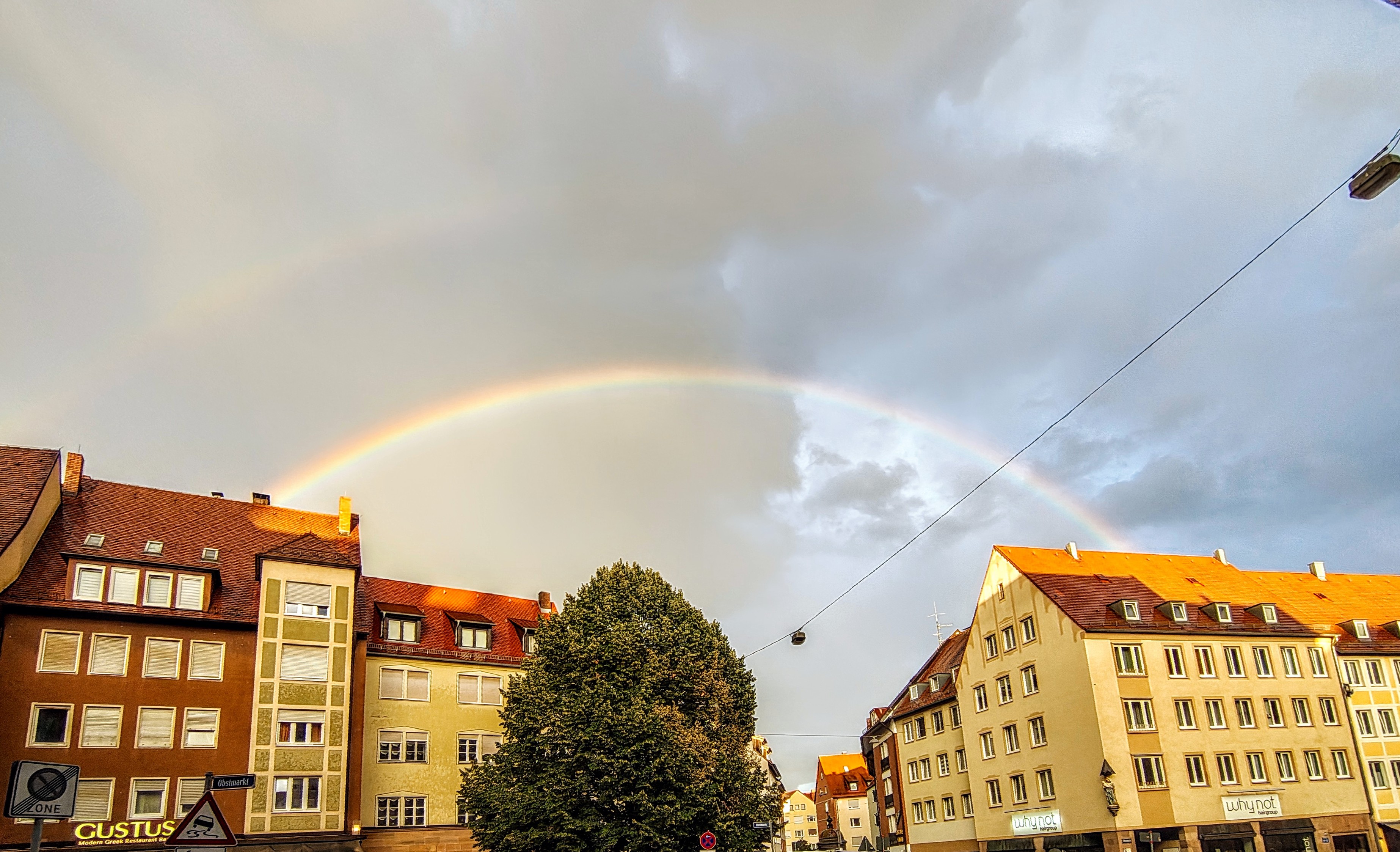 Regenbogen zwischen zwei Stadthäusern.